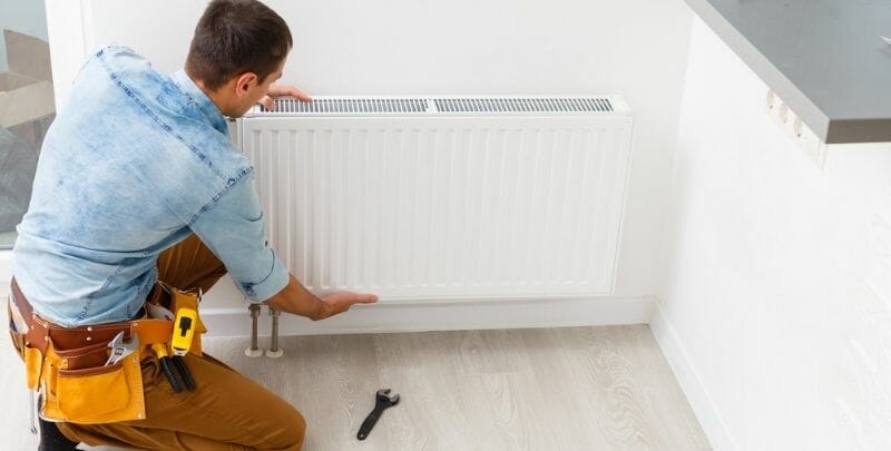 Why Should I Consider Hydronic Heating? Man Installs Hydronic Heating. Question, Why Should I Install Hydronic Heating?