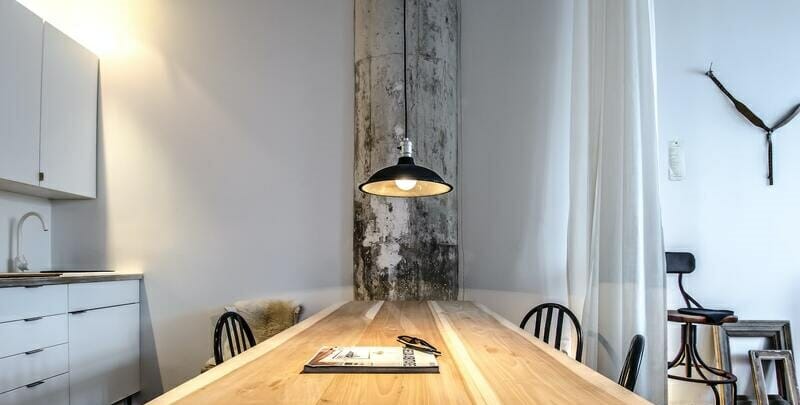 Pendant light hanging over a kitchen dining table