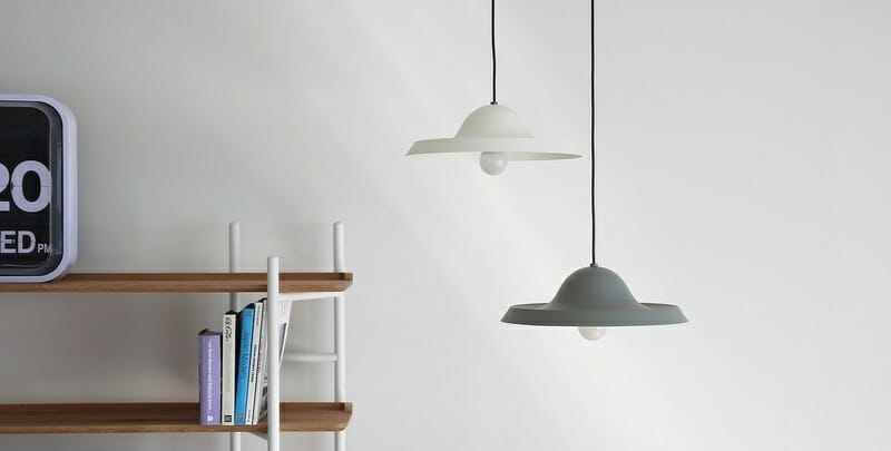 Pendant lights at different heights in a bedroom or study area
