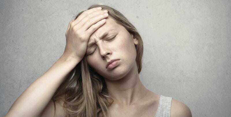 How to Test for Carbon Monoxide in Your Home women keeping hand on forhead