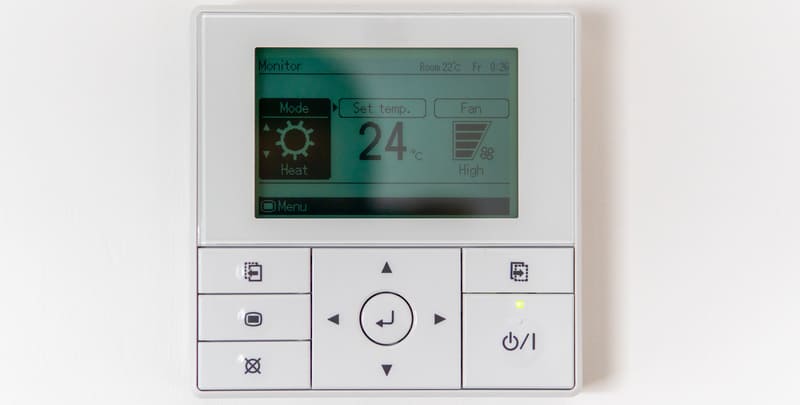 Wall control panel for air conditioner set to a temperature of 24 degrees Celsius. 