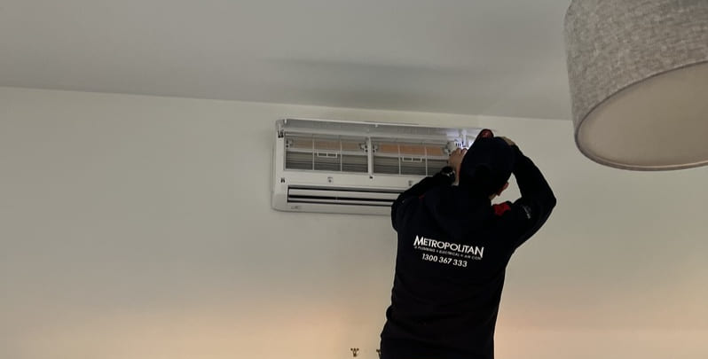 Air conditioning installation company technician installing split system. 